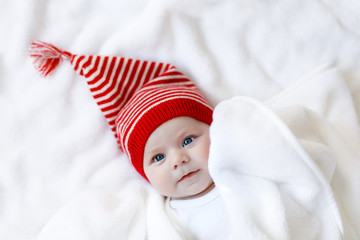 Cute adorable baby child with Christmas winter cap on white background