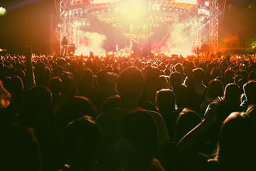 Fototapeta na wymiar Concert crowd watching rock band performance on the big stage.