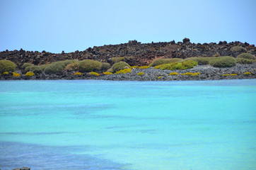 Naklejka premium Turquoise Ocean Water and a Volcanic Island in Canary Islands