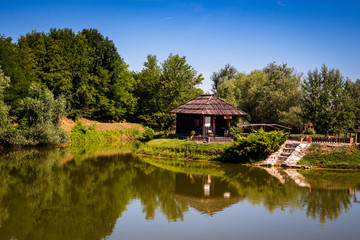 Fototapeta na wymiar Small wooden house by the lake 