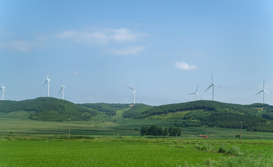 Wind power plants on the hills - green energy.