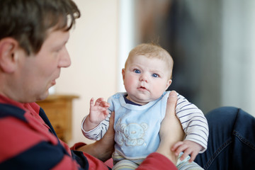 Happy proud young father with newborn baby daughter, family portrait togehter