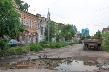 Astrakhan/Russia-20.06.2016:The street with cars and wooden old houses