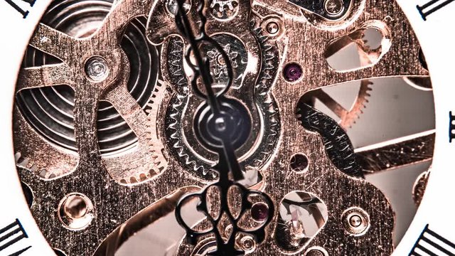 Motion control timelapse of a vintage pocket watch with visible clockwork mechanism / movement