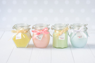 handmade candles in glass jars pastel colors, set