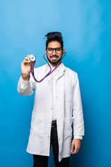 Portrait of Indian young male medical worker with stethoscope isolated on blue background