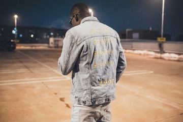 portrait of young black man posing and showing his back