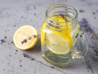 Lavender water with lemon in a jar on a blue background