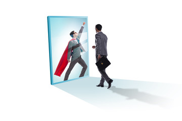 Fototapeta premium Businessman seeing himself in mirror as superhero