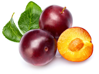 Fresh plum in cut with green leaf. Fruity still life. Healthy food. Isolated on white background.
