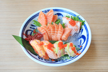 Sashimi sushi set served on ice against wooden table. Japanese food.