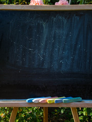 closeup of blackboard with pieces of coloured crayons