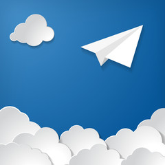 white paper plane with clouds on blue air background
