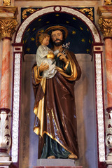 Saint Joseph holding baby Jesus, statue on the altar of Saint Joseph in the Church of Saint Barbara in Rude, Croatia