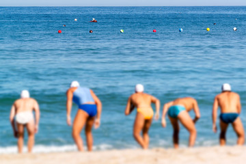 triathetes in swimming race in triathlon  competition in beach