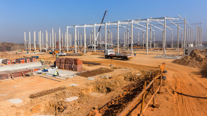 Industrial Construction Site New Warehouse Factory Building concrete columns with steel roof beams...