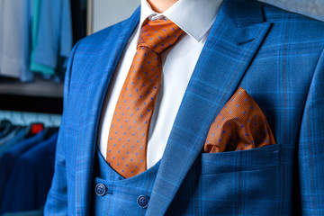 Stylish blue men's suit and white shirt with a brown tie. Male style. Close-up.