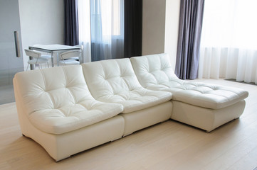 Modern furniture and interior design - white leather sofa in living room