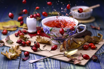 Cup of hot red tea with honey and dog-roses.