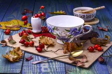 Cup  with honey and dog-roses.