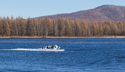 Fototapeta na wymiar Speedboat with high speed on the surface