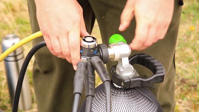 Scuba equipment in the process of being set up for a scuba dive. connection of the reducer with the balloon