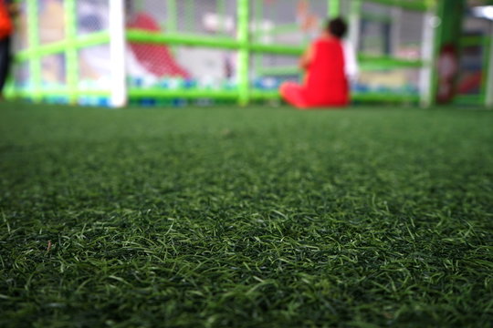Artificial turf in the playground and blurred background
