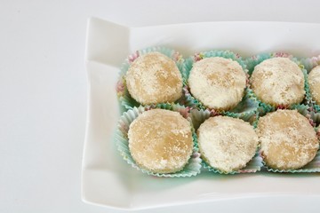 Tasty marzipan candies on the white table