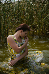 young woman in the water in dress