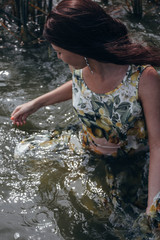 young woman in the water in dress