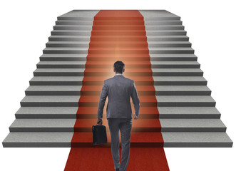 Young businessman climbing stairs and red carpet on white backgr