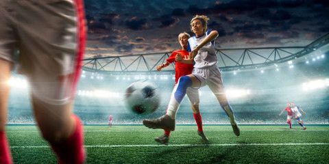 Female Soccer players performs an action play on a professional soccer stadium. Girls playing soccer