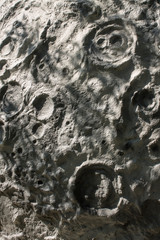 Imitation of the lunar surface of silver color with craters