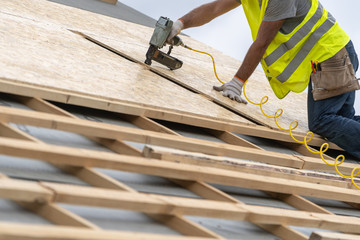 Building construction process of new wooden roof on wood frame house