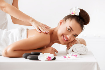 Obraz na płótnie Canvas Happy woman getting relax massage in spa center