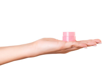 Female hand holding cream bottle of lotion isolated. Girl give jar cosmetic products on white background