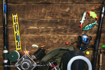 Fishing flat lay background with a copy space. Fishing gear on a wooden table.