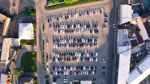 Aerial top down view of city car parking with many autos from above