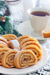 Biscuit roll with apple jam in white Christmas decor, selective focus