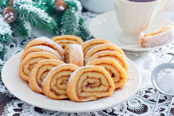 Biscuit festive roll with apple jam on a white bowl, horizontal