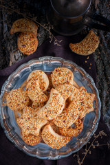 Shortbread cookies with nuts in the forest decor, top view, selective focus