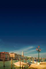 Grand Canal and Campanile tower at Piazza San Marco during sunset, Venice, Italy, summer time, moody scenic sundown