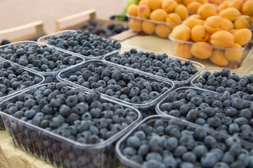 Fresh blueberries on the table at the farmer's market counter.