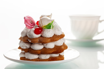 Cake with protein cream on a white glass table