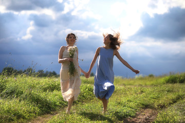 Young girls are walking in the field