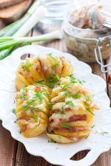Harmonium potato with bacon and cheese on a white plate, selective focus