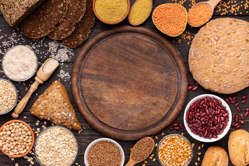 Cutting board with copy space surrounded by gluten free grains