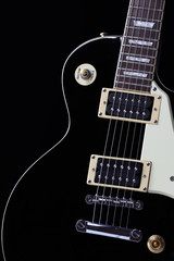 Fototapeta na wymiar Classic black electric guitar body with white scratchplate
