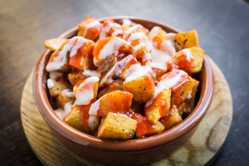 Spanish potatoes patatas bravas for tapas with tomato and spicy sauce