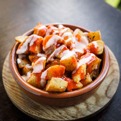 Spanish potatoes patatas bravas for tapas with tomato and spicy sauce